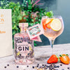 Boothstown Strawberry Gin in a glass and a bottle of Boothstown Gin